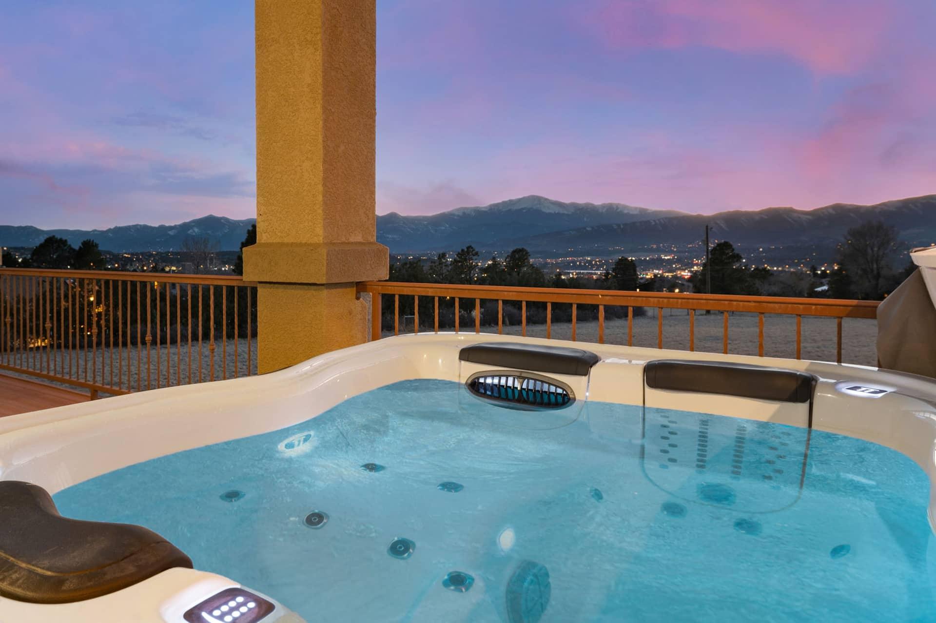 The private hot tub on the rear deck at sunset, with the mountains on the horizon