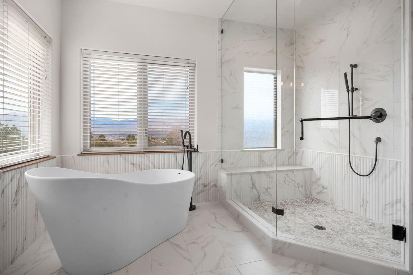 Primary bathroom with a freestanding soaking tub and glass shower